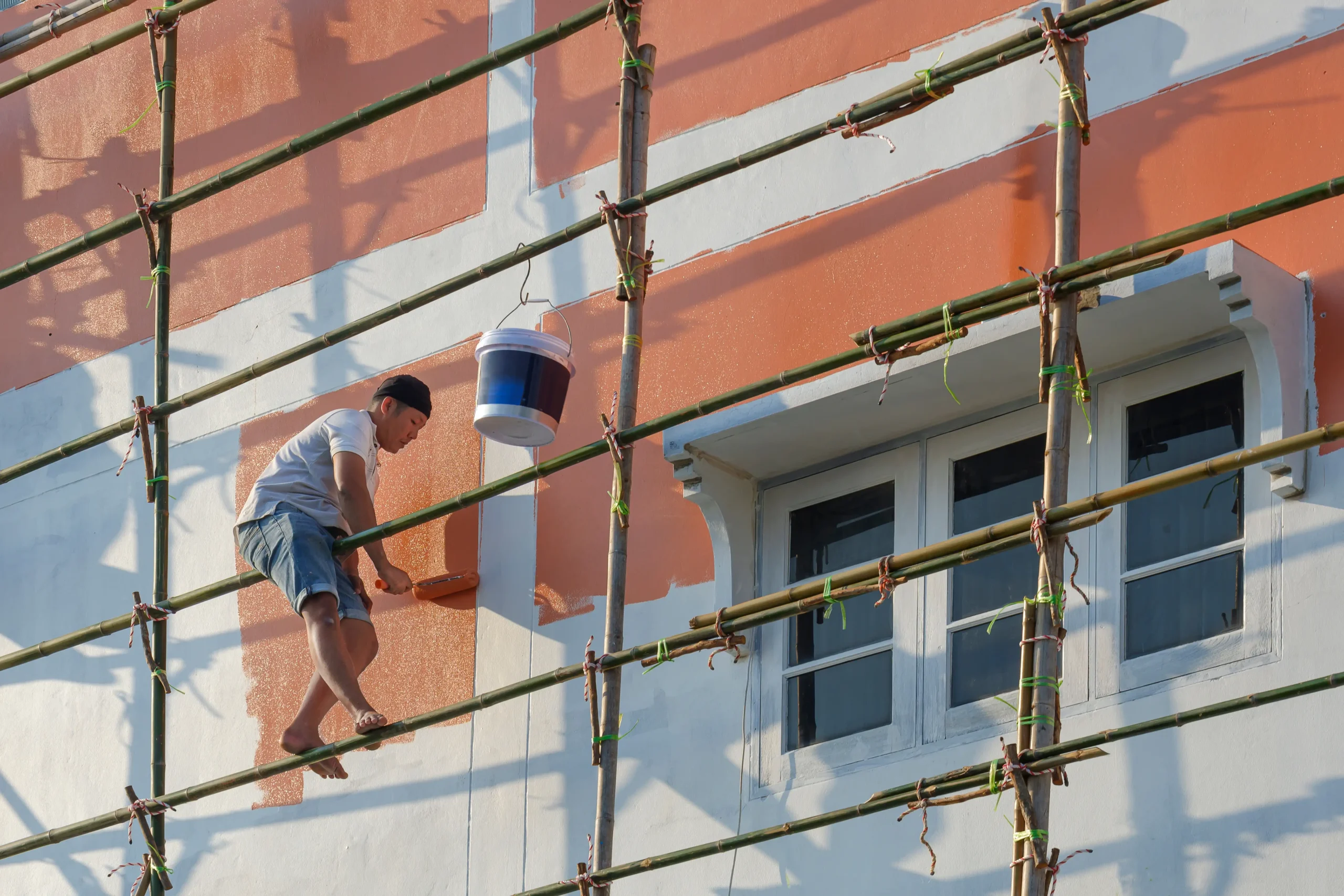 exterior wall painting work on building using scaffolding at adura paint emporium